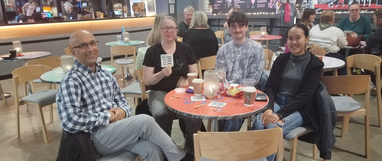 a collection of people sitting in a cafe